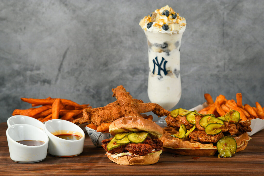 spicy fried chicken sandwich with fries and a blueberry cheesecake shake