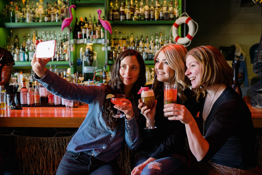 women taking a selfie together holding drinks at the Water Witch in Utah