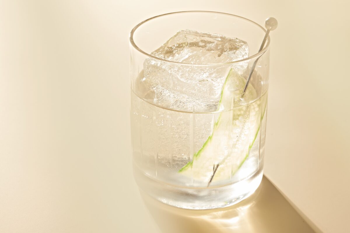 a white negroni cocktail with light shining through it