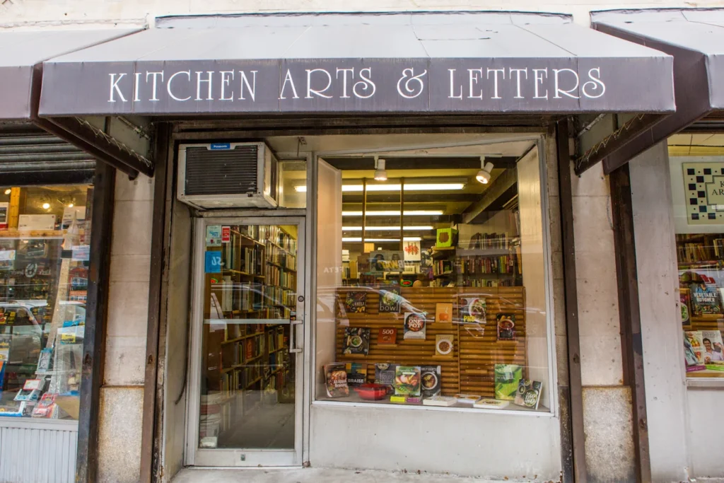 The facade and black awning reading Kitchen Arts & Letters