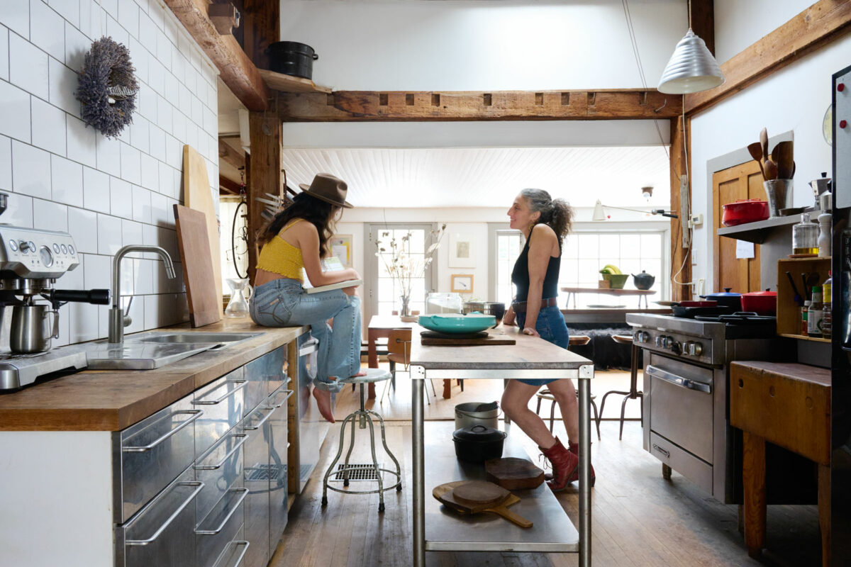 a mother and daughter talking in their farmhouse kitchen