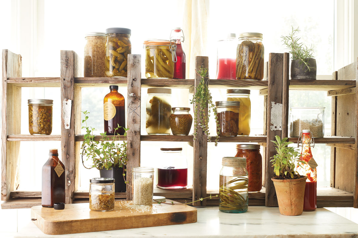fermentation jars on wooden shelves