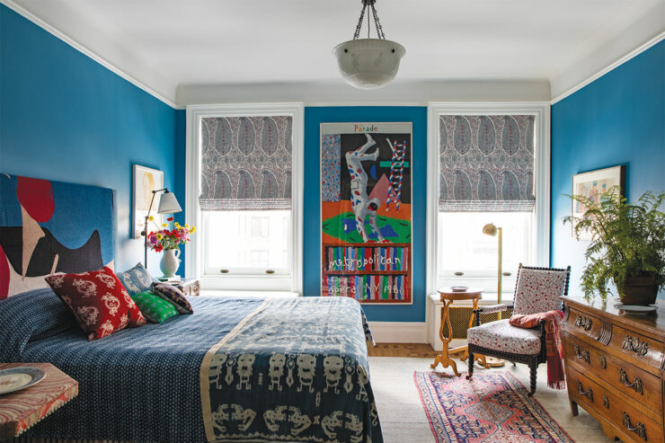 a bedroom painted blue with interesting furniture