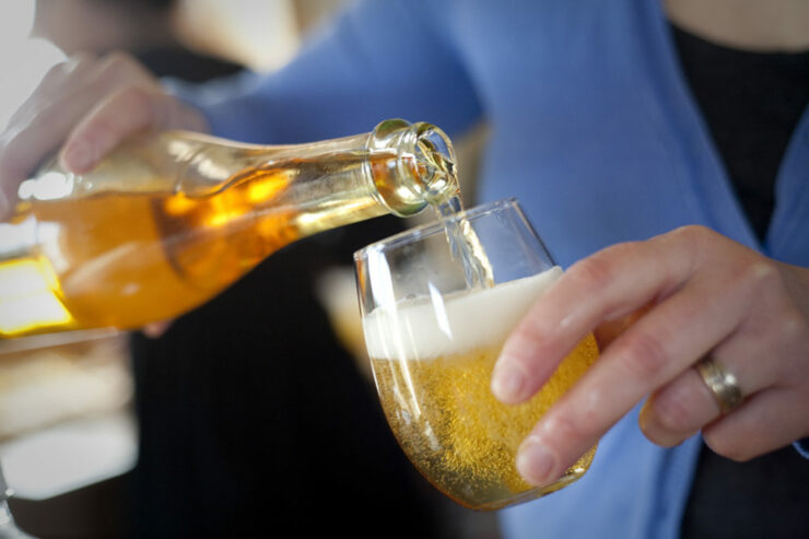 pouring hard cider into a glass